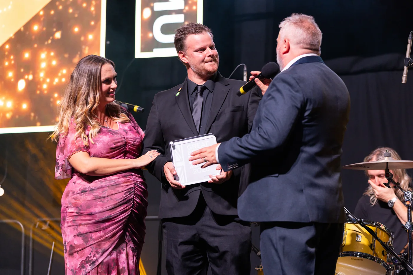 The Swan's award winners holding the Great British Pub Awards 2026 trophy on stage while being interviewed